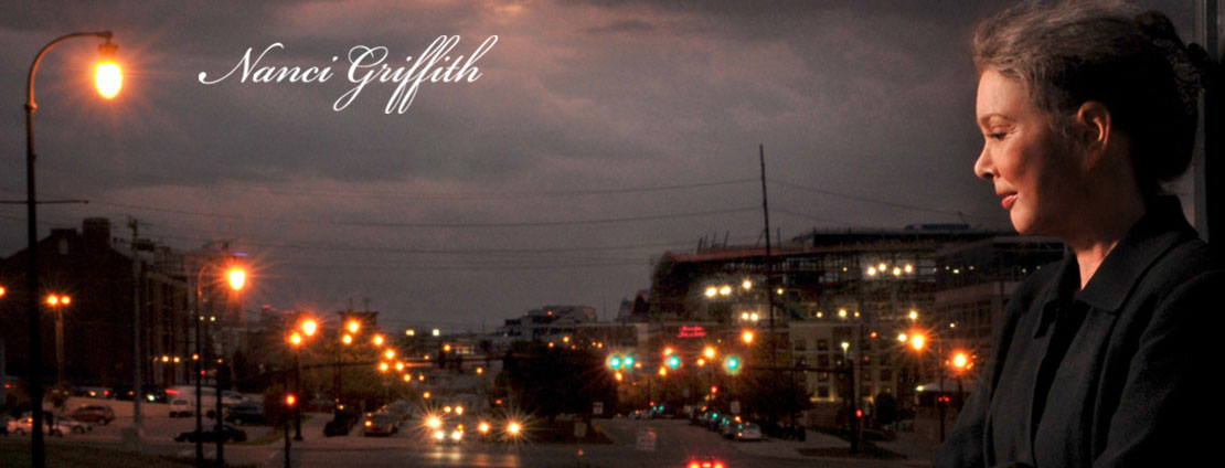 Nanci Griffith overlooking city lights at dusk